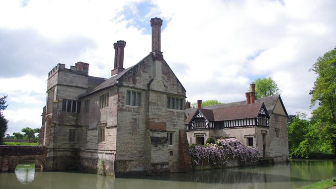 A view of Baddesley Clinton across the moat in springtime